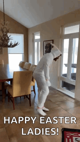 A Woman In A White Bunny Costume Is Dancing In A Living Room With The Words Happy Easter Ladies Below Her GIF