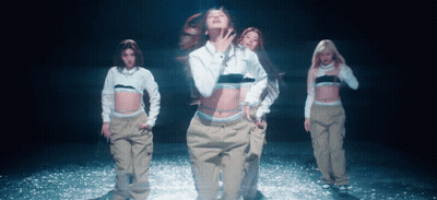 A Woman In A White Calvin Klein Shirt Is Dancing With Other Women GIF
