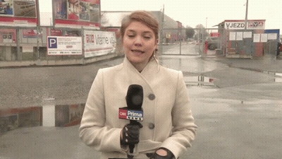A Woman In A White Coat Is Holding A Microphone That Says Cnn Prima News GIF