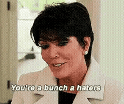 A Woman In A White Coat Is Saying `` You 'Re A Bunch A Haters '' . GIF