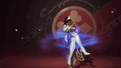 A Woman In A White Costume Is Standing In Front Of A Playing Card Symbol GIF
