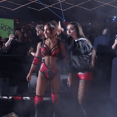 A Woman In A White Crop Top That Says Cc On It GIF