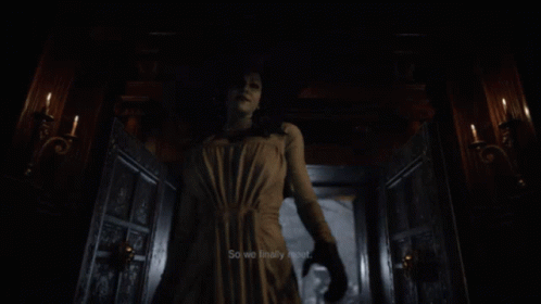 A Woman In A White Dress And Hat Is Holding A Sword GIF