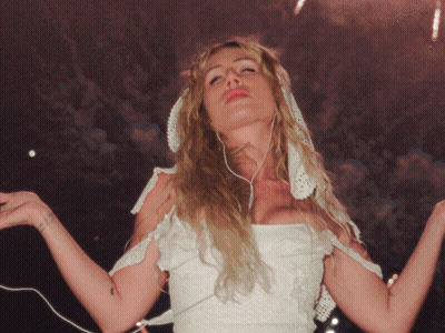A Woman In A White Dress Has A Tattoo On Her Wrist That Says ' I Love You ' On It GIF