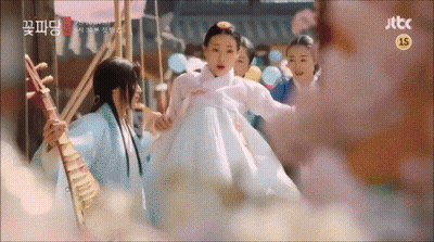 A Woman In A White Dress Is Being Held By A Man Playing A Musical Instrument .. GIF