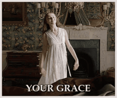 A Woman In A White Dress Is Dancing In Front Of A Fireplace With The Words " Your Grace " Written Below Her GIF