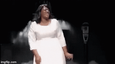 A Woman In A White Dress Is Dancing On A Stage With The Words `` I Made It '' Written Below Her . GIF