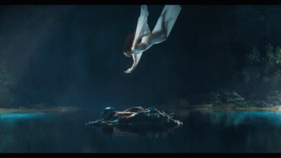 A Woman In A White Dress Is Flying Through The Air GIF