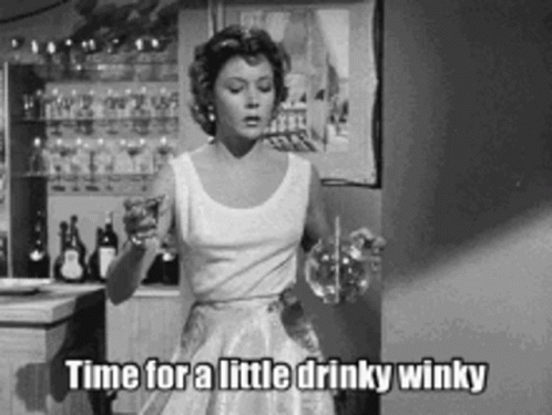 Woman In White Dress Holding Wine Glass Saying Little Drinky Winky GIF