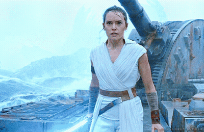 A Woman In A White Dress Is Holding A Light Saber In Her Hand GIF