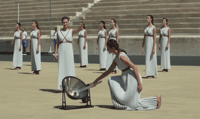 A Woman In A White Dress Is Kneeling In Front Of A Group Of Women In White Dresses GIF