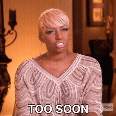 A Woman In A White Dress Is Making A Face And Says Too Soon . GIF