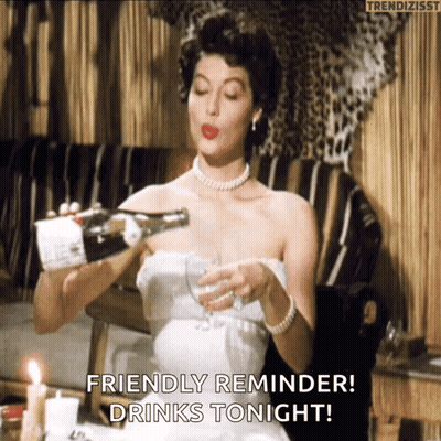 A Woman In A White Dress Is Pouring Champagne Into A Glass . GIF