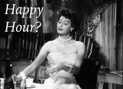 A Woman In A White Dress Is Sitting At A Table With The Words Happy Hour Above Her GIF