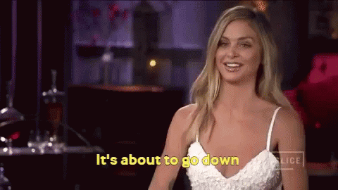A Woman In A White Dress Is Smiling And Says It 'S About To Go Down . GIF