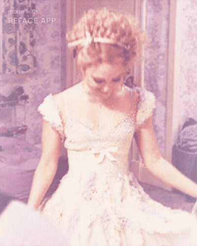 A Woman In A White Dress Is Smiling With The Words Made With Reface App Below Her GIF