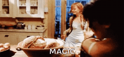 A Woman In A White Dress Is Standing In A Kitchen Next To A Bowl Of Bread And A Bowl Of Eggs . GIF