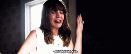 A Woman In A White Dress Is Standing In Front Of A Window With Her Hands In The Air . GIF