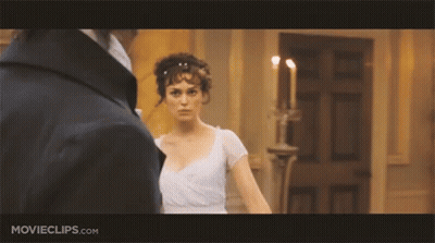 A Woman In A White Dress Is Standing Next To A Man In A Black Jacket .. GIF