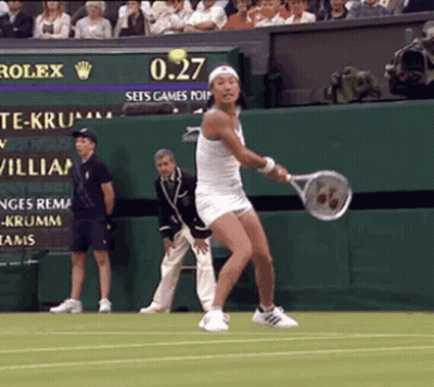 A Woman In A White Dress Is Swinging A Tennis Racquet On A Tennis Court While The Scoreboard Says 0.27 GIF