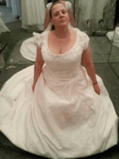A Woman In A White Dress Sits On The Floor GIF