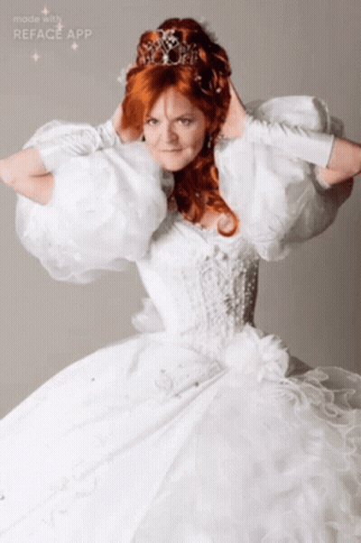 A Woman In A White Dress With A Tiara On Her Head Is Made With The Reface App GIF