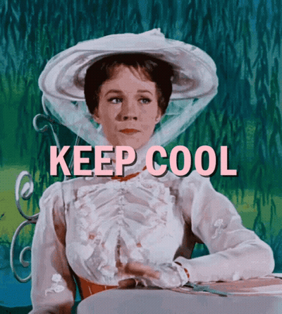A Woman In A White Hat Is Sitting At A Table With The Words " Keep Cool " Written Above Her GIF