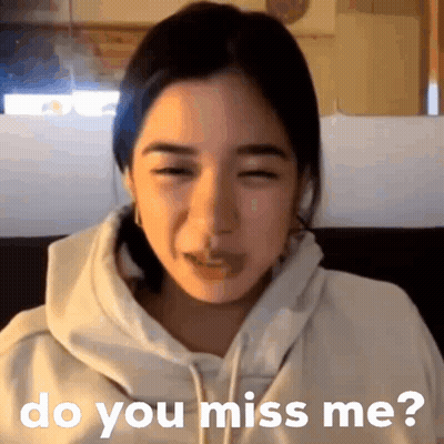 A Woman In A White Hoodie Is Sitting On A Couch And Says Do You Miss Me GIF