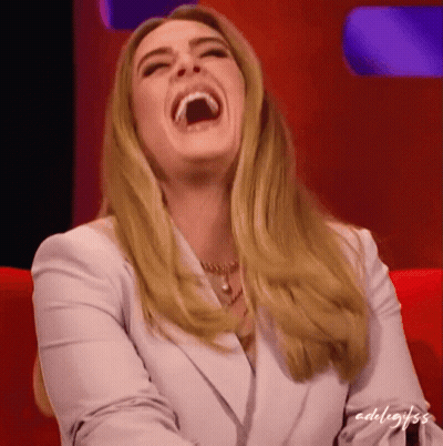 A Woman In A White Jacket Is Laughing With The Word Adel Written On The Bottom Right GIF
