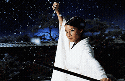 A Woman In A White Kimono Holds A Sword In The Snow GIF