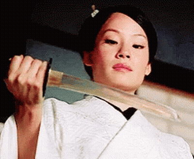 A Woman In A White Kimono Is Holding A Large Sword In Her Hands . GIF