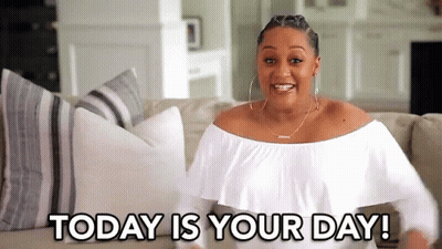 A Woman In A White Off The Shoulder Top Is Sitting On A Couch With The Words `` Today Is Your Day '' . GIF