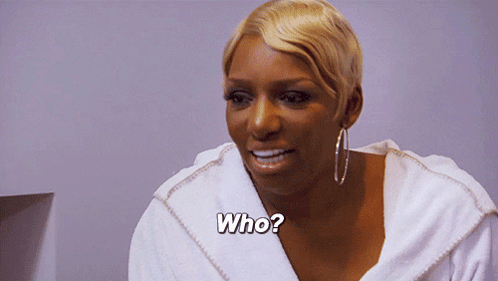 A Woman In A White Robe Is Asking The Question Who GIF