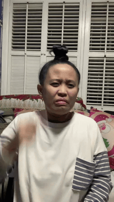 A Woman In A White Shirt And Striped Sleeves Is Making A Funny Face GIF