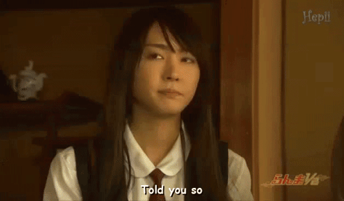 A Woman In A White Shirt And Tie Is Talking To Someone And Says Told You So . GIF