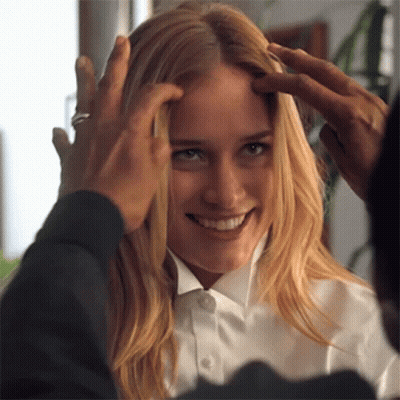 A Woman In A White Shirt Is Being Touched By A Man In A Black Shirt GIF
