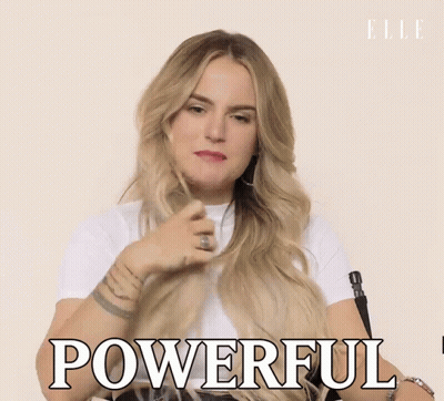 A Woman In A White Shirt Is Holding Her Hair And Says Powerful GIF