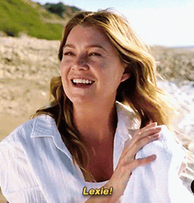 A Woman In A White Shirt Is Laughing And Says Lexie GIF