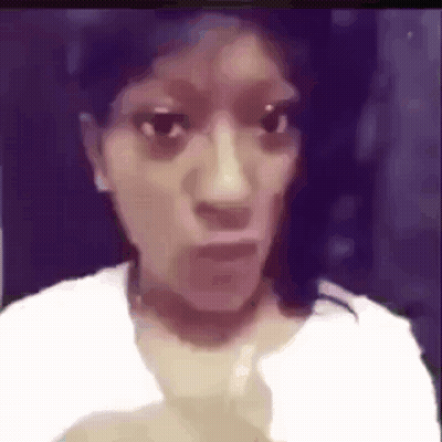 A Woman In A White Shirt Is Making A Funny Face In A Blurry Photo . GIF