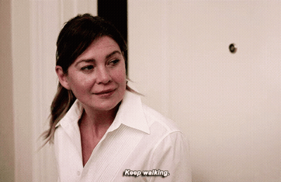 A Woman In A White Shirt Is Saying " Keep Walking " GIF