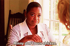 A Woman In A White Shirt Is Sitting At A Table Talking To Another Woman . GIF