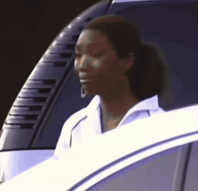 a woman in a white shirt is sitting in a car