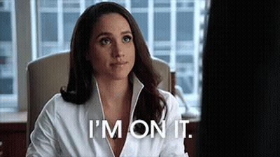 A Woman In A White Shirt Is Sitting In A Chair And Saying `` I 'M On It . '' GIF