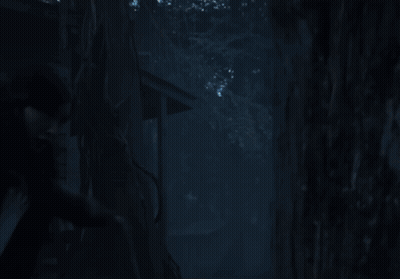 A Woman In A White Shirt Is Standing In Front Of A Glass Wall GIF