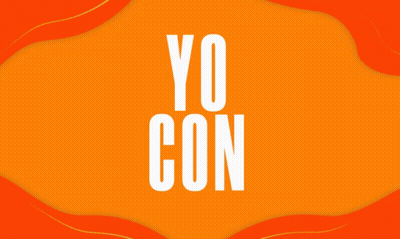 A Woman In A White Shirt Stands With Her Arms Crossed In Front Of An Orange Background GIF