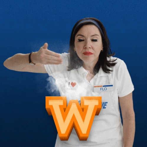 A Woman In A White Shirt With The Name Flo On It GIF