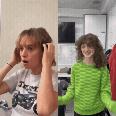 A Woman In A White Shirt With The Word Tum On It Adjusts Her Hair GIF