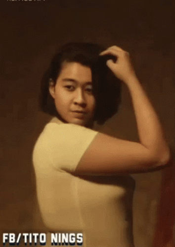 A Woman In A White Shirt With The Words Fb / Tito Nings Written On The Bottom GIF