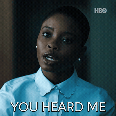A Woman In A White Shirt With The Words You Heard Me Above Her GIF