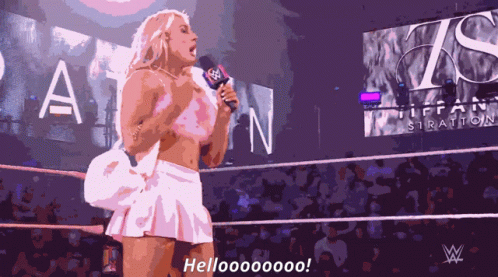 A Woman In A White Skirt Is Holding A Microphone And Says Hellooooooo GIF
